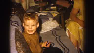 Nebraska (1959): Blond Boy Playing With His Toy Sitting On The Couch Next To His