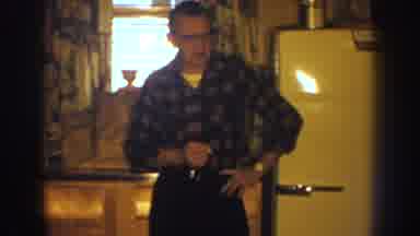 Nebraska (1959): Man In A Plaid Shirt Bumming A Cigarette In The Kitchen By The