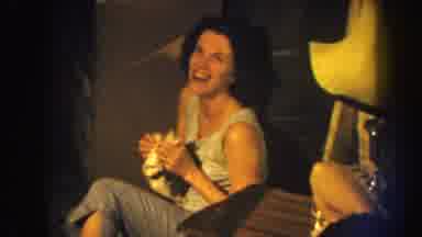 Nebraska (1959): Woman Sitting On The Floor Laughing With A Cloth On Her Face