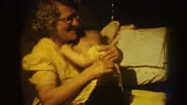 Nebraska (1959): Woman Wearing White Dress Hugs Small Boy Wearing Black Shorts On