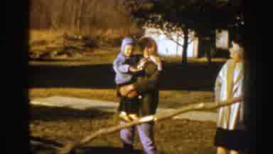 Nebraska (1959): Man Having A Family Moment With Wife And Kid As He Gathers Wood
