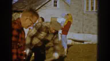 Nebraska (1959): People Picking Up Broken Tree Limbs From Ground On A Sunny Day