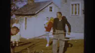 Nebraska (1959): People Loading Broken Tree Limbs Onto Blue Truck On A Sunny Day