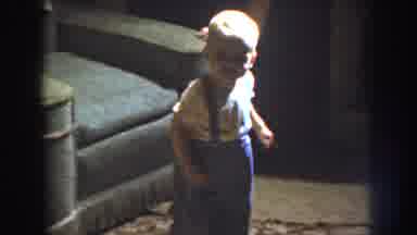 Nebraska (1959): Blond Baby Dressed In Blue And Yellow Laughing And Walking Around