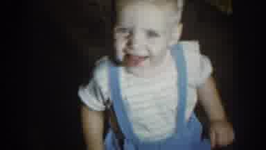 Nebraska-1959: Child Smiling and Garden State Farm Supply Truck