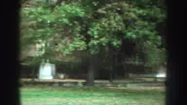 Nebraska (1959): Several Cars Stopped With Background Building And Several Trees