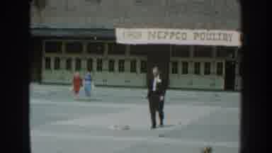 Nebraska (1959): People Are Walking In Dresses And Suits In Front Of The Poultry