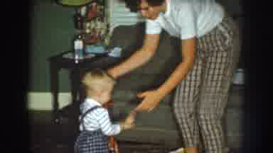 Nebraska (1959): Woman Dancing With Child Indoors And Child Smiling