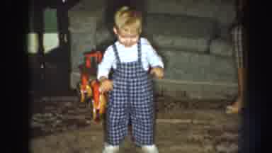 Nebraska (1959): A Blonde Toddler Dressed In A Jumpsuit Dances And Claps On A