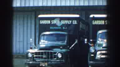 Nebraska (1959): Old Trucks Near A Building