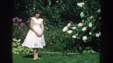 Nebraska (1959): Barefoot Caucasian Woman In A White Dress Standing Beside