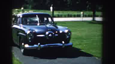 Nebraska (1959): Cars Passing On The Street Car Entering The Grassy House Yard