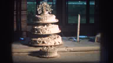 Nebraska (1959): A Large White Wedding Cake On A Table Decorated With White