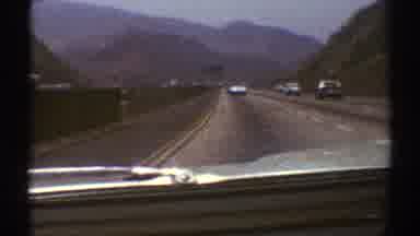 Los Angeles California (1969): Cars At High Speed On A City Road On A Cloudy Day
