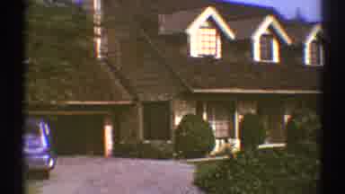 Los Angeles California (1969): Blue Car Parked In Open Garage Of Tan Home On A