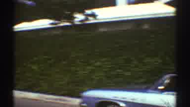 Los Angeles California (1969): View Of Blue Car Parked By Green Hedges On A Clear