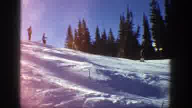 Aspen Colorado (1961): Person Wearing Black Coat Skis Downhill On A Bright Sunny