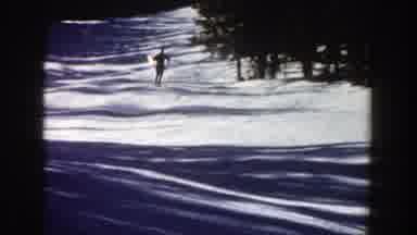 Aspen Colorado (1961): Skiers Skiing Down A Snow Covered Slope With Evergreen
