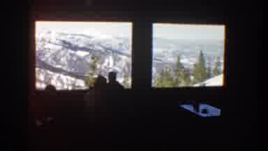 Aspen Colorado (1961): Couple Looking At Snow Covered Mountains Through Large