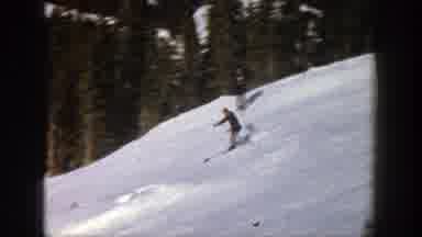 Aspen Colorado (1961): A Snow Skier Skis Down A Ski Lane In Use By Other Skiers