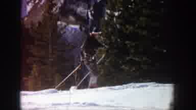 Aspen Colorado-1961: Man Wearing Black Hat Skis Uphill On A Clear Day