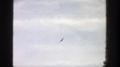 Aspen Colorado (1961): View Of Airborne Red And White Plane On A Sunny Day