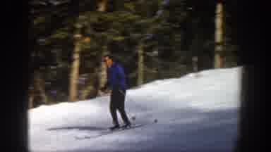 Aspen Colorado (1961): Man In Blue Coat Skiing In The Snow With Other People