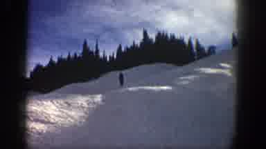 Aspen Colorado (1961): Person Skis Down The Slope Past The Camera And Jumps Into