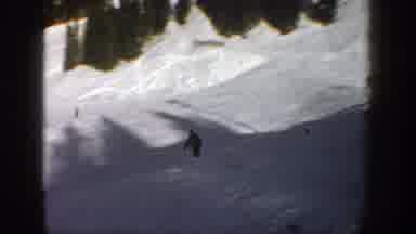 Aspen Colorado (1961): Skiers On The Slopes One Jumps In Air And Lands Further
