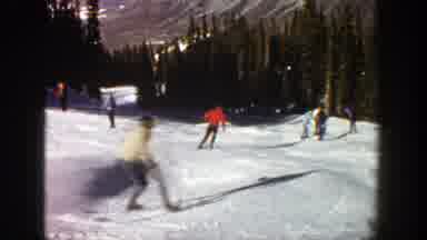 Aspen Colorado (1961): Three People Skiing Downhill On A Bright Sunny Day