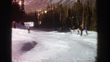 Aspen Colorado (1961): People Skiing Down A Snowy Mountain Surrounded By Trees