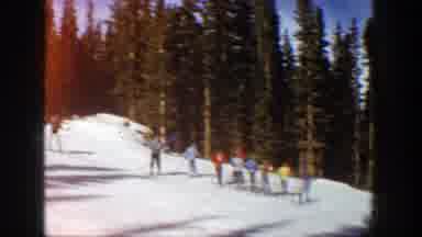 Aspen Colorado (1961): Group Of Skiers Taking Their Turn To Descend Snow-Covered