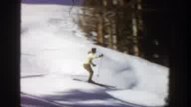 Aspen Colorado (1961): A Woman Wearing A Yellow Heavy Winter Clothes And Skiing In