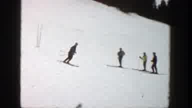 Aspen Colorado (1961): A Person Skis Down A Small Mountain In Front Of Three Other