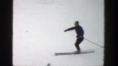 Aspen Colorado (1961): A Man Wearing A Blue Coat And Using Skis And Ski Poles