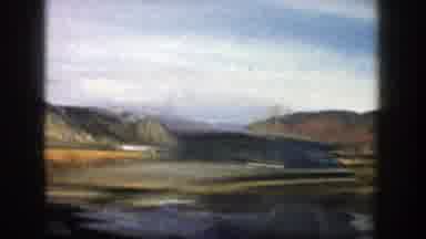Aspen Colorado (1961): A Vehicle Drives Through High Desert Country With Sage