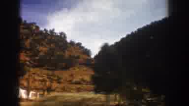 Aspen Colorado (1961): Vehicle Moves Down Road Through Mountainous Region Passes