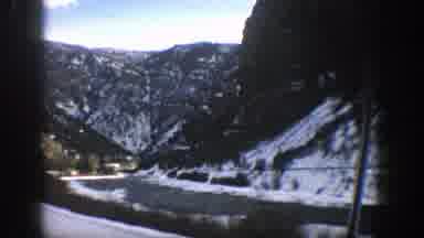 Aspen Colorado (1961): Vehicle Moves Down Curved Road In Mountainous Region Snow