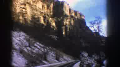 Aspen Colorado (1961): Scenic View Of Large Rocky Cliff-Side From A Driving Car
