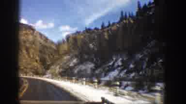 Aspen Colorado (1961): Approaching View Of Brown Mountains Trees And Blue Sky On A