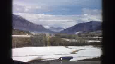 Aspen Colorado (1961): Passing View Of Mountains Trees And Blue Sky On A Cloudy