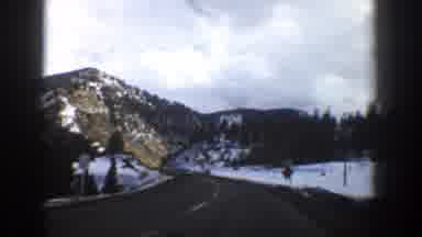 Aspen Colorado (1961): Approaching View Of Mountains And Green Trees On A Cloudy