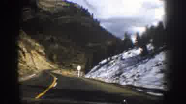 Aspen Colorado (1961): Vehicle Moves Down Winding Road Through Mountain Region