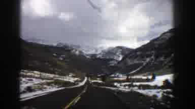 Aspen Colorado (1961): Approaching View Of Snow Covered Mountains And Clouds On A