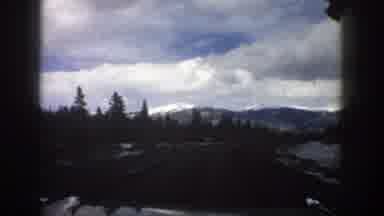 Aspen Colorado (1961): Looking Out The Windshield Of A Car At The Mountains Trees