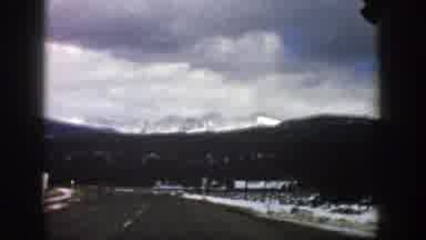 Aspen Colorado (1961): Driving On Highway In Winter With A View Of Snow Capped