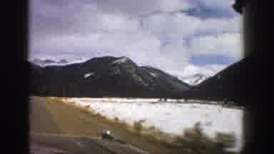 Aspen Colorado (1961): Scenes Of Vehicle Moving Down Road In Mountainous Region