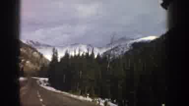 Aspen Colorado (1961): Approaching View Of Snow Covered Mountains Green Trees And