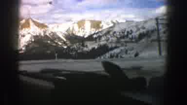 Aspen Colorado (1961): Vehicle Moving Down Road Through Mountainous Region Snow On