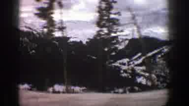 Aspen Colorado (1961): Someone Is Driving Fast Down A Road During Winter